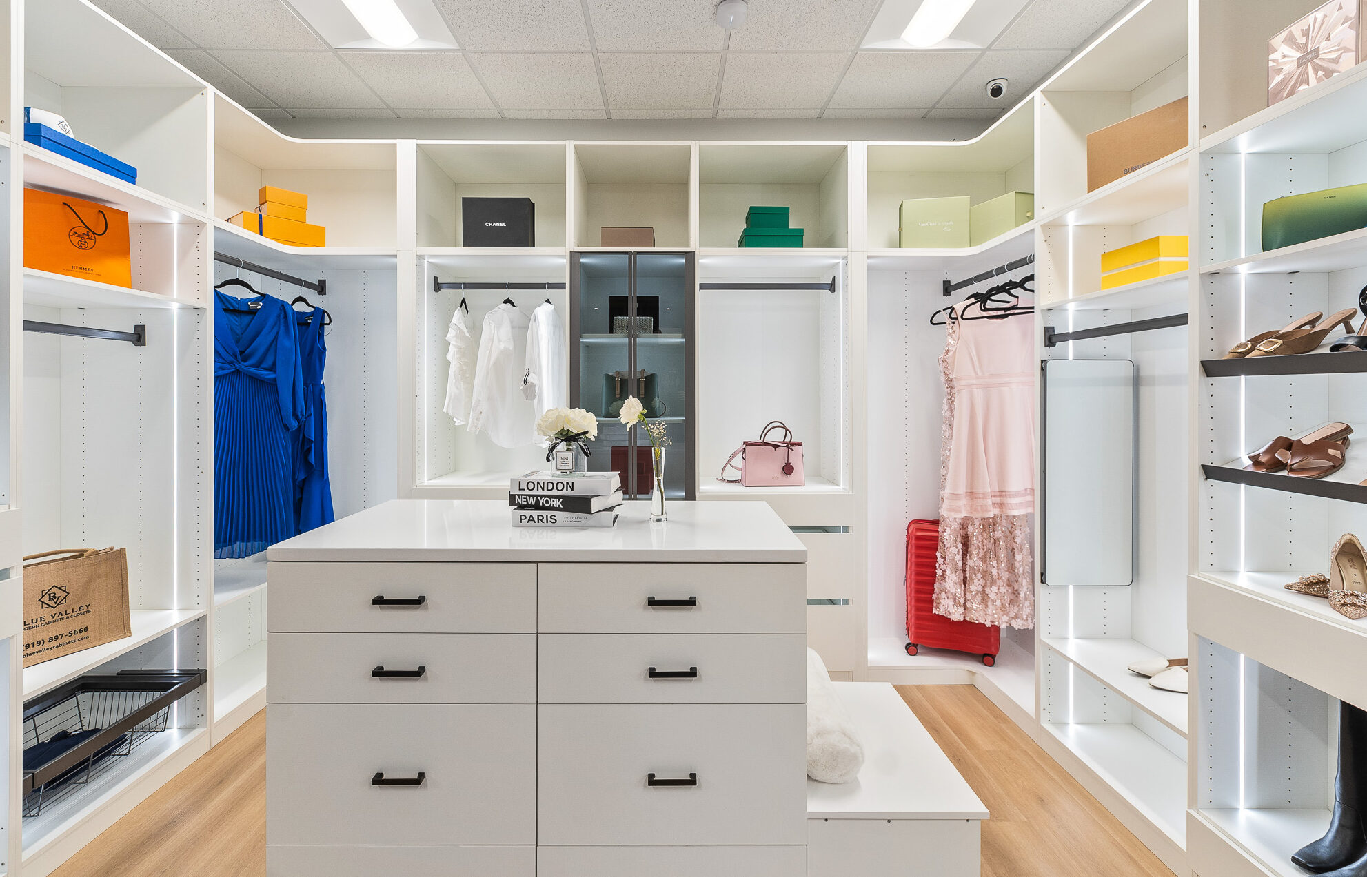 White walk-in closet system with shoe shelves, hanging rods, and drawers