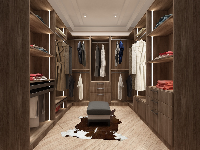 Walnut walk-in closet with drawers, baskets, hanging storage, and lighting